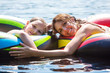 Mother and Daughter floating on a lake