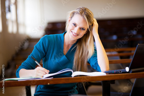 Foto: happy female college student sitting in classroom happy female college student sitting in classroom