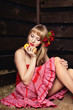 woman in a red dress with an apple in hands on a mow