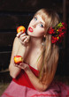 woman in a red dress with an apple in hands on a mow