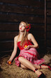 woman in a red dress with an apple in hands on a mow