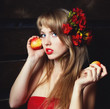 woman in a red dress with an apple in hands on a mow