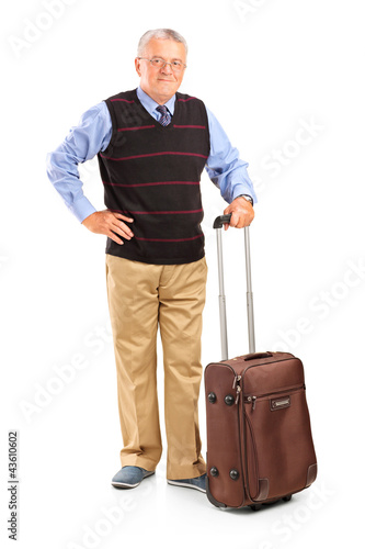 Photo: Full length portrait of a mature man holding a suitcase Full length portrait of a mature man holding a suitcase