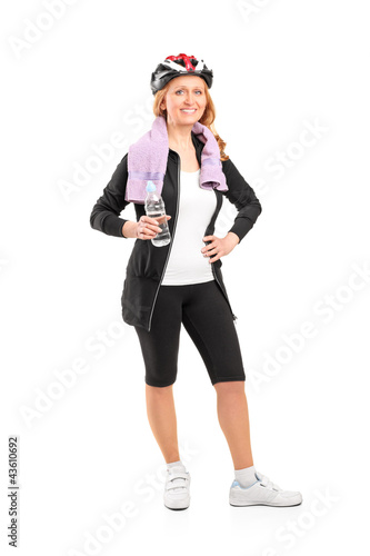 Photo: Full length portrait of a woman holding a bottle of water after Full length portrait of a woman holding a bottle of water after