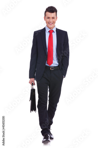 Photo: young business man carrying a suitcase young business man carrying a suitcase