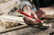 Photo: Carpenter Marking a Wooden Plank Carpenter Marking a Wooden Plank