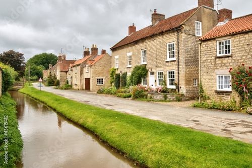 Photo: Quaint cottages and stream in an English village Quaint cottages and stream in an English village