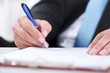 Photo: Close up of businessman signing a contract. Close up of businessman signing a contract.
