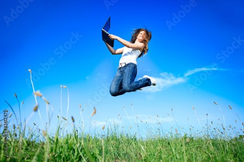 Photo: Jumping woman with laptop Jumping woman with laptop