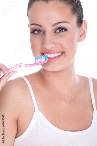 Photo: Beautiful young woman brushing her teeth Beautiful young woman brushing her teeth