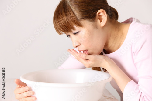 Photo: young woman feel nauseated young woman feel nauseated