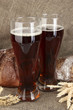 two glasses of kvass with bread on canvas background close-up