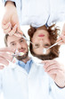 Dentist and his assistant show different medical instruments