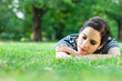 Young woman relaxing and listening to music outdoors