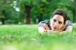 Young woman relaxing and listening to music outdoors