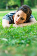 Young woman relaxing and listening to music outdoors