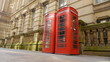 Two red english telephone boxes. Camera move.