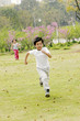 A boy and a girl running in the park