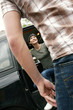 Back shot of a man waiting for his girlfriend to get down from the van