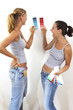 Two women comparing their selected colour cards