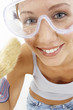 Close-up of a woman with goggles holding a brush
