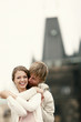 A guy locking his arm around his girlfriend's shoulder