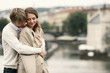 A guy warming up his girlfriend by hugging her from the back 