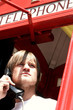 Foto: A man making a phone call in the telephone booth A man making a phone call in the telephone booth
