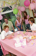 Photo: A boy popping out strings of paper in the air shocking his parents and siblings A boy popping out strings of paper in the air shocking his parents and siblings