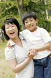 A woman holding her son in her arms