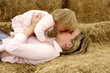 A lady giving her young daughter a kiss