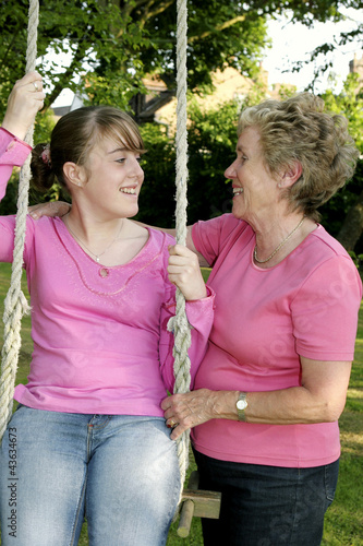 Photo: An old lady helping to swing her granddaughter An old lady helping to swing her granddaughter