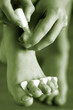 A pair of hands putting nail color on the toe nail