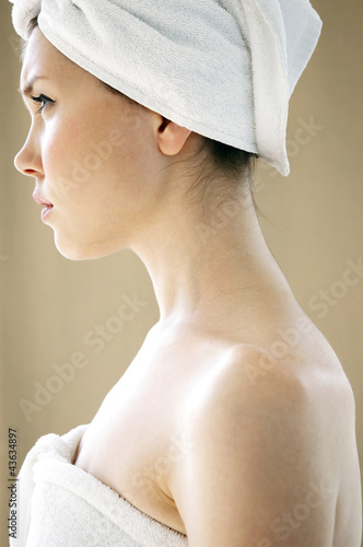 Photo: Side shot of a woman with her hair and body wrapped up in towel Side shot of a woman with her hair and body wrapped up in towel