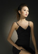 Studio shot of an elegant looking lady in black dress