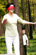A boy hiding from his blindfolded grandmother 