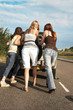 Three women pushing a car
