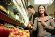 A couple shopping for fruits