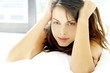 Woman looking at the camera while lying on the bed 
