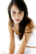 Woman in all white smiling at the camera 