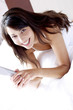 Woman lying on the bed smiling 