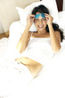 Woman lying on the bed wearing an eye gel
