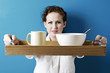 Woman holding a tray of breakfast