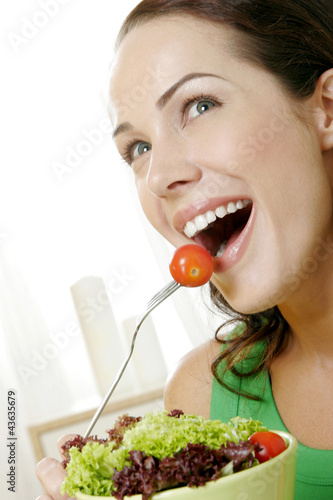 Photo: Woman holding a bowl of salad Woman holding a bowl of salad