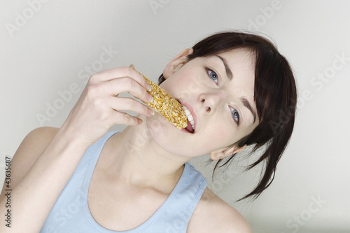 Photo: Woman eating biscuit Woman eating biscuit