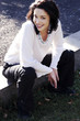 Photo: Woman sitting by the road side Woman sitting by the road side
