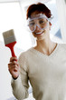 Woman in goggles holding a paintbrush