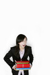 Businesswoman carrying a heavy stack of books