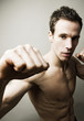 Shirtless man striking a kung fu pose for the camera