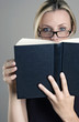 Bespectacled woman reading book